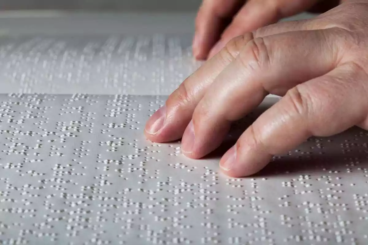 Persona leyendo un libro en braille