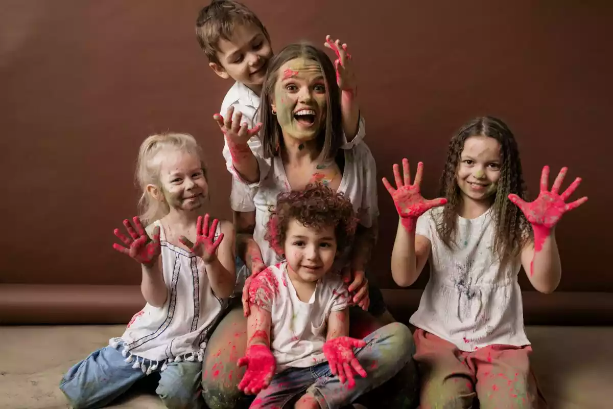 Una madre y sus hijos con las manos pintadas